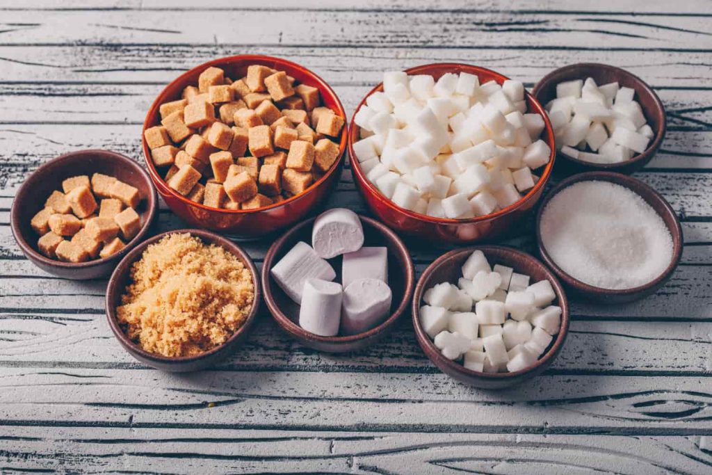 A variety of bowls containing acidic and sugary foods arranged on a table.