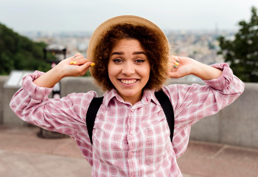 A smiling girl standing in ovation with a cheerful expression.