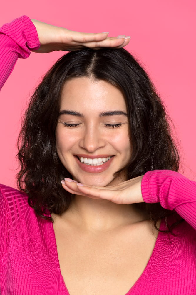 Girl smiling and showing her teeth.