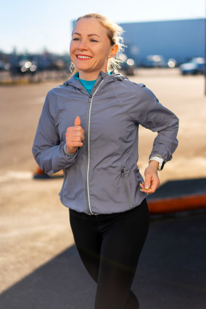 A girl running on the ground with a joyful expression.