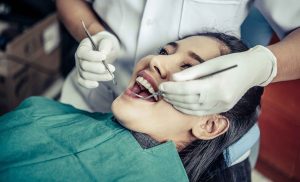 Dentists treating patient's teeth in a professional dental clinic in OKC